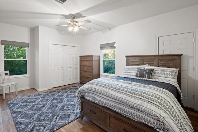 bedroom with a closet, ceiling fan, and dark wood-type flooring