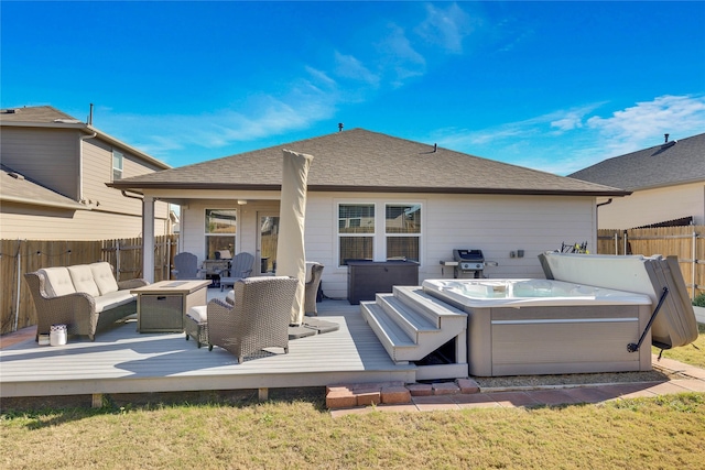 rear view of property with a wooden deck, a hot tub, and an outdoor living space