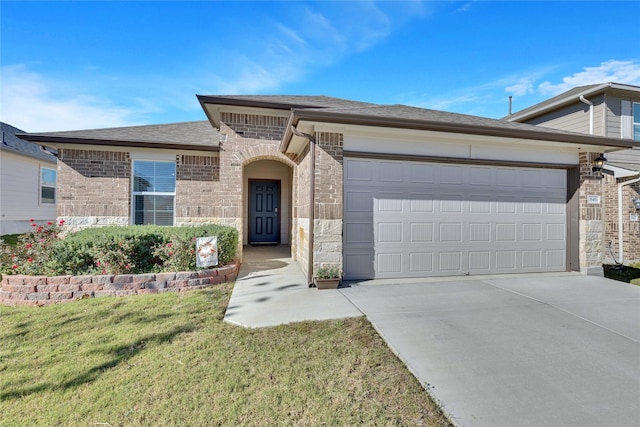 view of front of house featuring a garage and a front yard