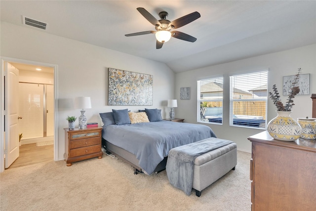 carpeted bedroom featuring ensuite bathroom, ceiling fan, and lofted ceiling