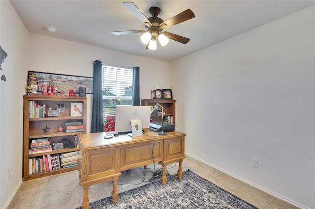 carpeted office featuring ceiling fan