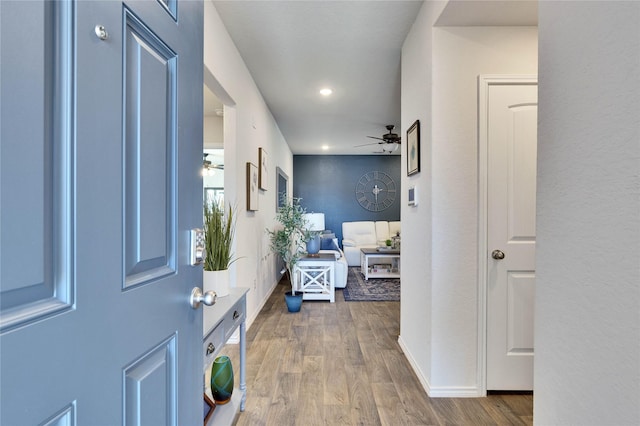 hallway with hardwood / wood-style flooring