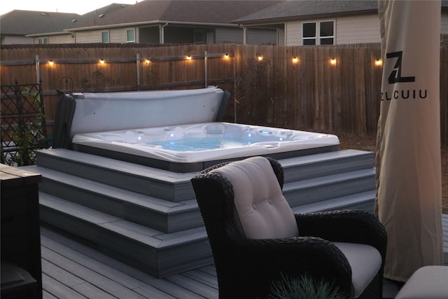 wooden deck featuring a covered hot tub