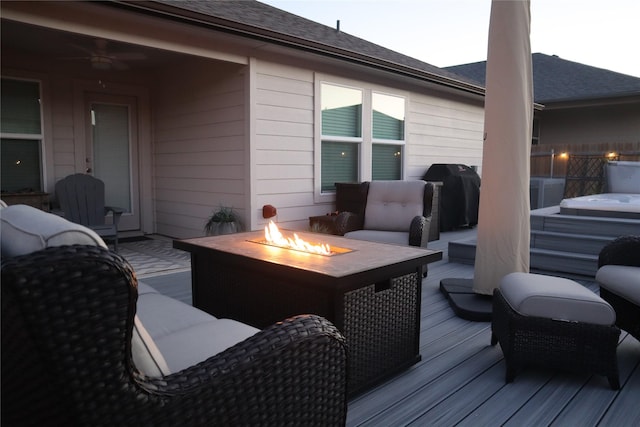 deck featuring an outdoor living space with a fire pit and area for grilling