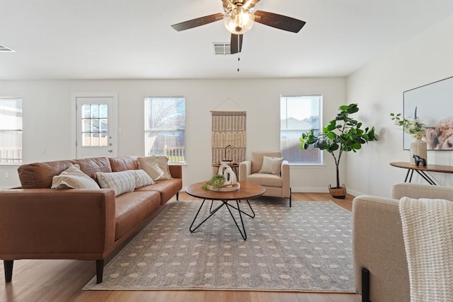 living room with hardwood / wood-style floors, ceiling fan, and a healthy amount of sunlight