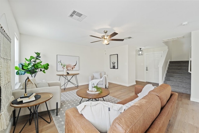 living room featuring ceiling fan and light hardwood / wood-style floors