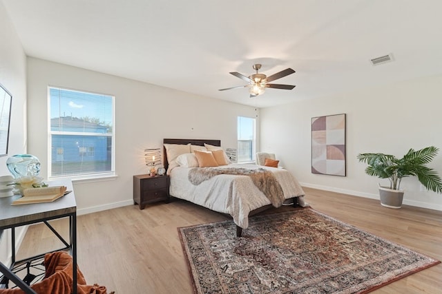 bedroom with ceiling fan and light hardwood / wood-style flooring