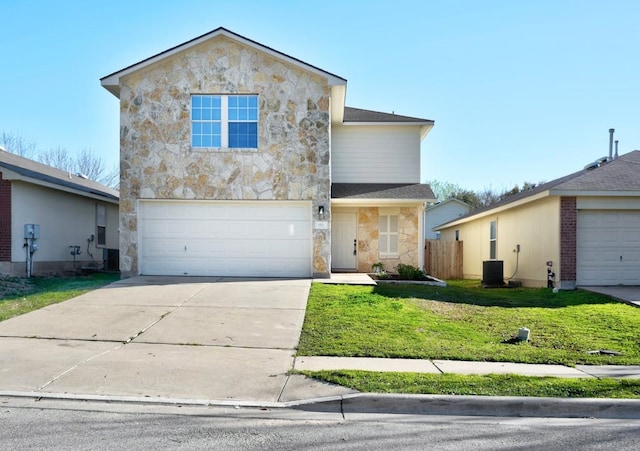 view of property featuring a front yard, a garage, and central air condition unit