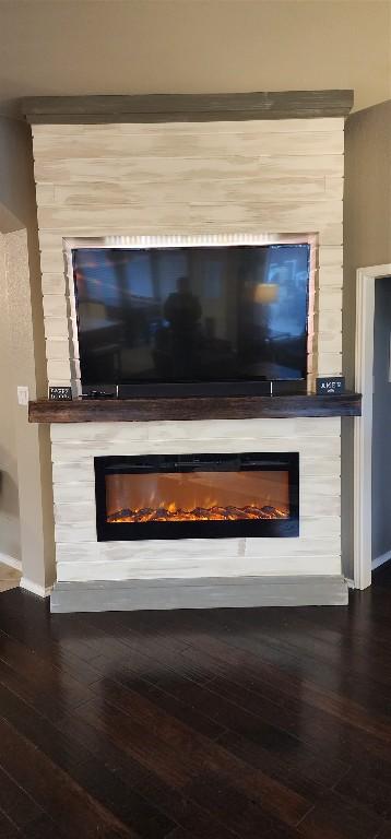 details featuring a large fireplace and hardwood / wood-style flooring