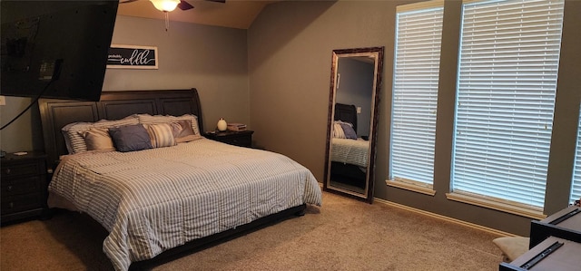 bedroom with ceiling fan, light carpet, and vaulted ceiling