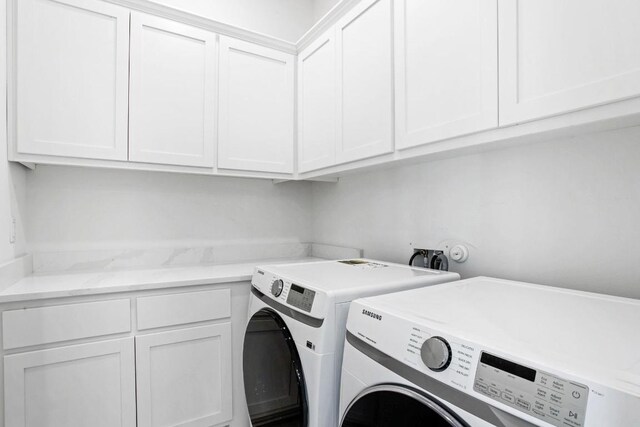 laundry room featuring cabinet space and separate washer and dryer