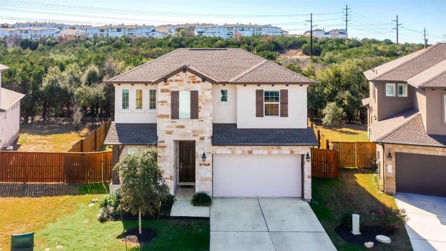 view of front of property with a garage and a front yard