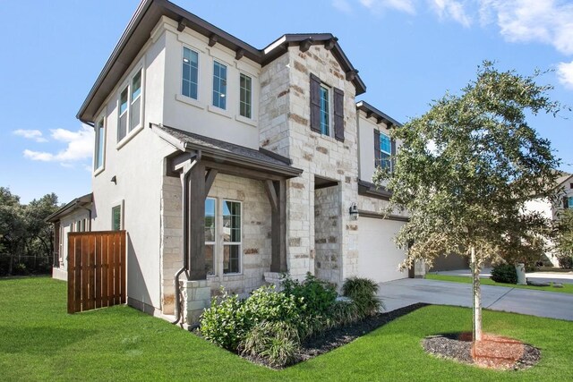 view of front of property featuring a front lawn and a garage