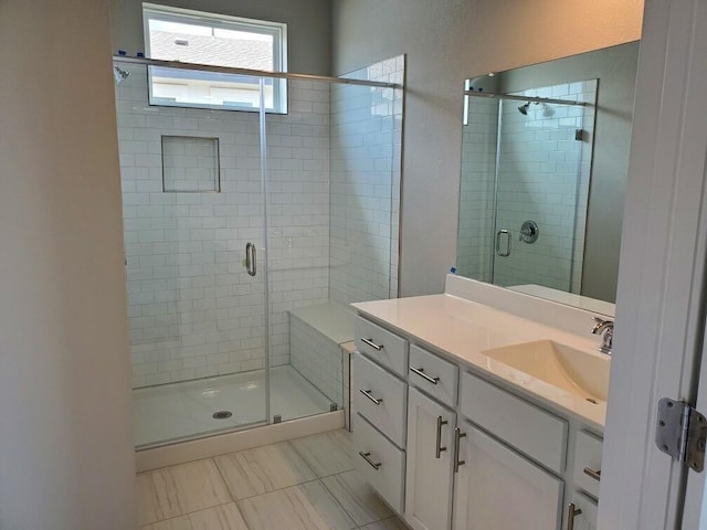 bathroom with vanity and a shower with door