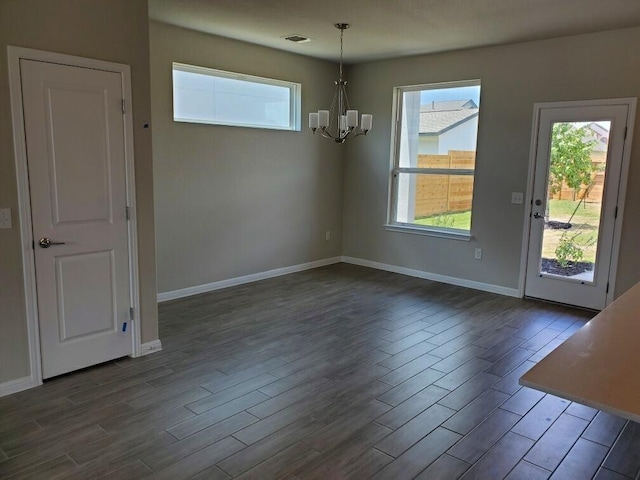 unfurnished dining area featuring an inviting chandelier