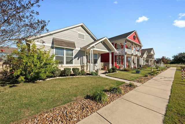 view of front of home with a porch, a balcony, and a front yard