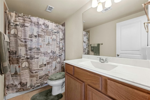 bathroom featuring tile patterned floors, vanity, and toilet