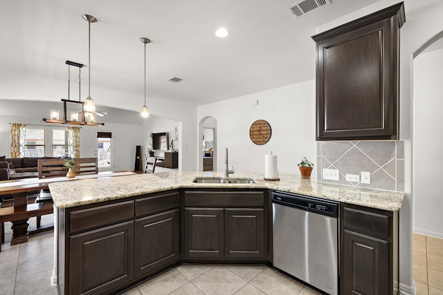 kitchen featuring pendant lighting, stainless steel dishwasher, decorative backsplash, sink, and dark brown cabinets