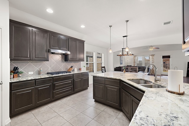 kitchen featuring ceiling fan, tasteful backsplash, sink, stainless steel gas cooktop, and dark brown cabinets