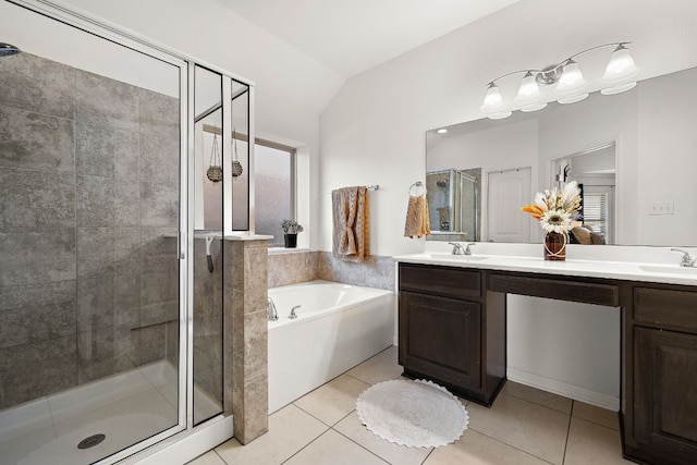 bathroom with plus walk in shower, vaulted ceiling, tile patterned floors, and vanity