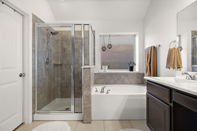 bathroom with vanity, vaulted ceiling, tile patterned floors, and shower with separate bathtub