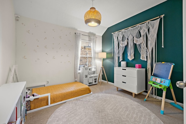 bedroom featuring lofted ceiling and light carpet