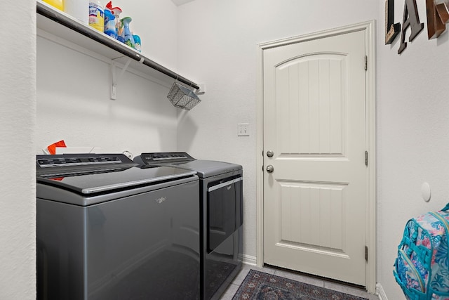 washroom with tile patterned flooring and washing machine and dryer