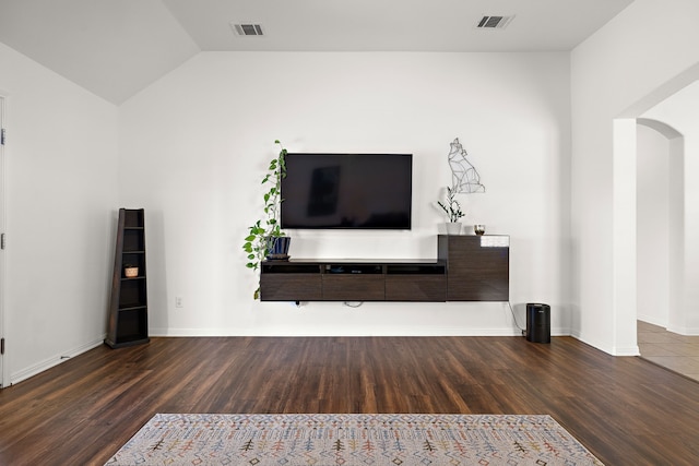 unfurnished living room featuring dark wood-type flooring and lofted ceiling