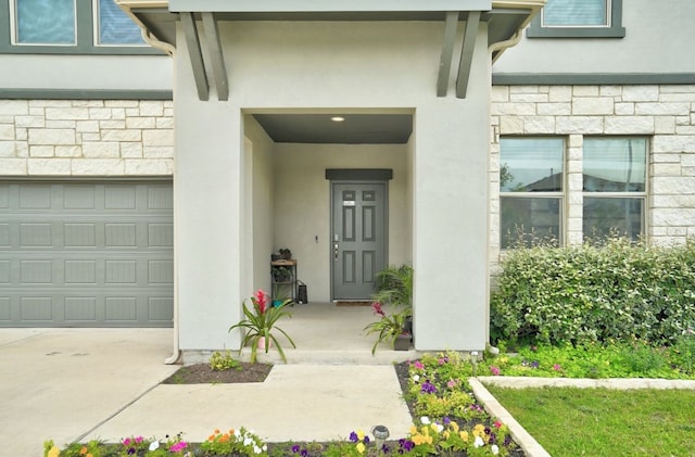 doorway to property with stone siding and stucco siding