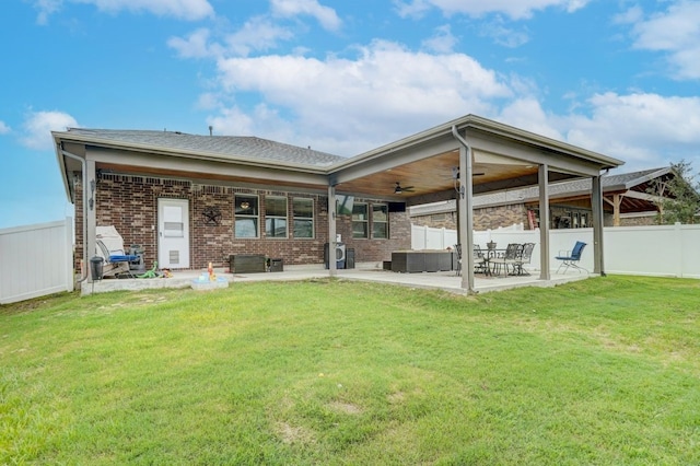 back of house with a lawn, ceiling fan, and a patio area