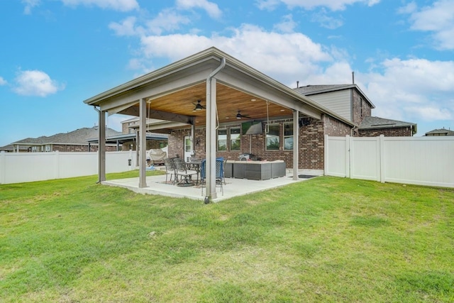 view of yard with an outdoor living space, a patio, and ceiling fan