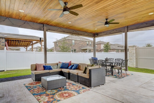 view of patio / terrace with ceiling fan, a fenced backyard, outdoor lounge area, and outdoor dining space