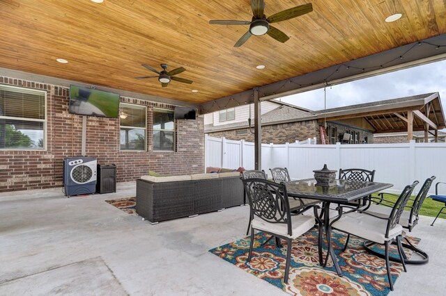 view of patio / terrace with ceiling fan, outdoor dining space, an outdoor hangout area, and fence