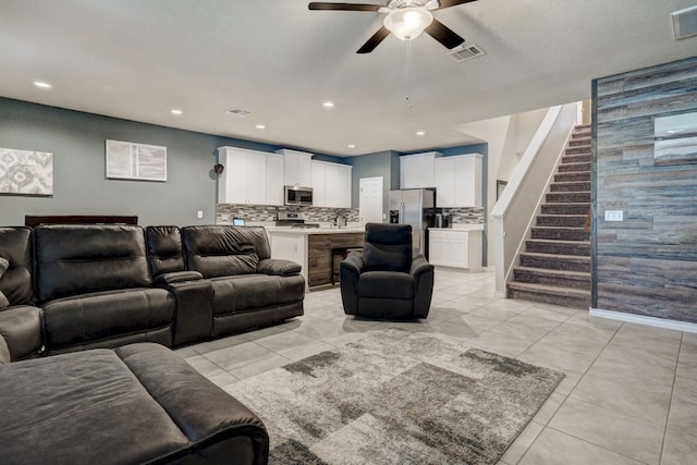 living area featuring recessed lighting, visible vents, and stairs