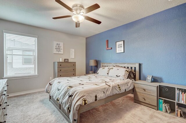 bedroom with carpet floors, baseboards, and a ceiling fan