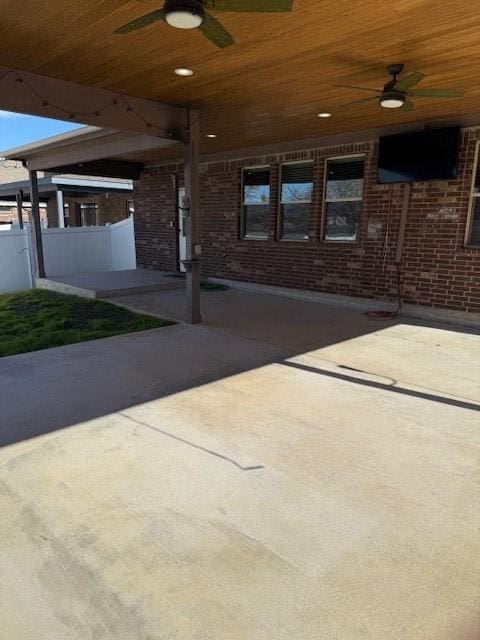 view of patio / terrace featuring ceiling fan and fence