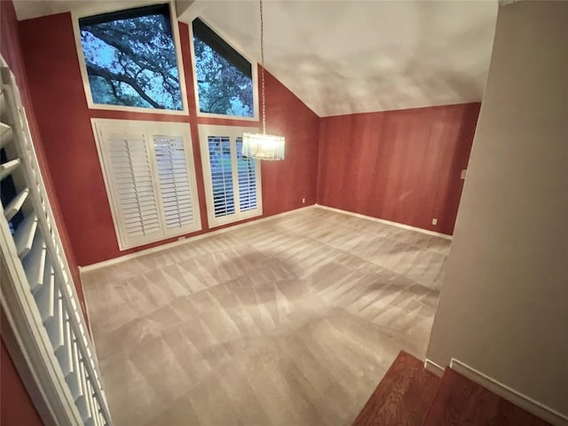 additional living space featuring carpet flooring, beam ceiling, high vaulted ceiling, and an inviting chandelier