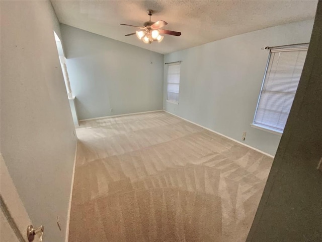 spare room with carpet, ceiling fan, and a textured ceiling