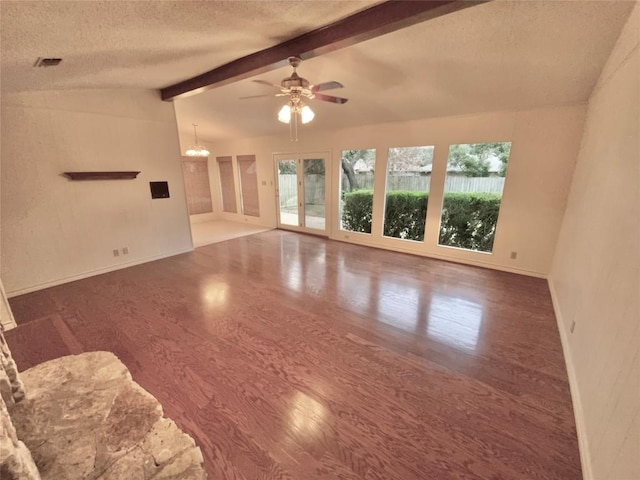 unfurnished living room featuring ceiling fan with notable chandelier, a textured ceiling, vaulted ceiling with beams, and dark wood-type flooring