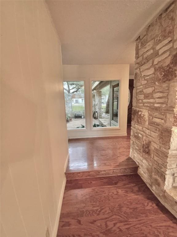 corridor featuring dark hardwood / wood-style floors