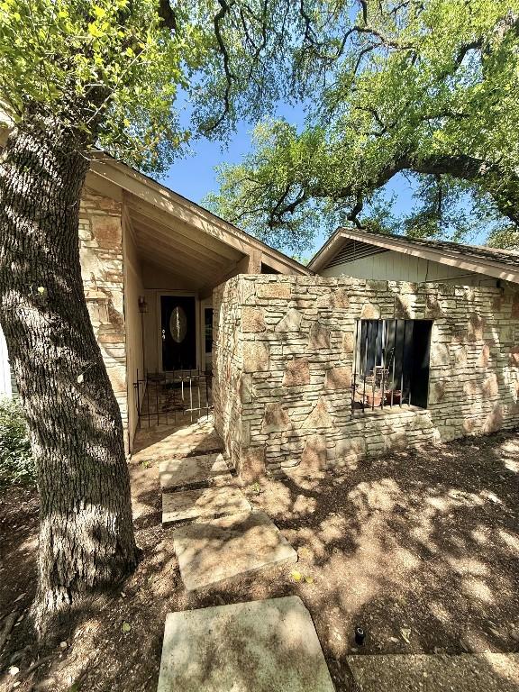 view of side of property featuring stone siding