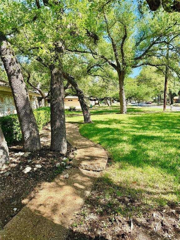 view of property's community featuring a yard