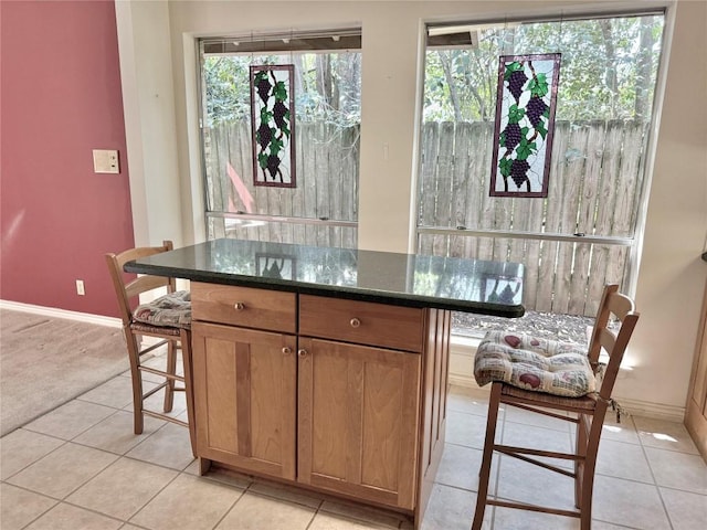 bar with baseboards and light tile patterned floors