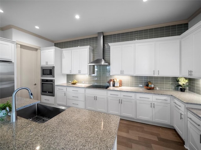 kitchen with white cabinetry, sink, wall chimney exhaust hood, and stainless steel appliances