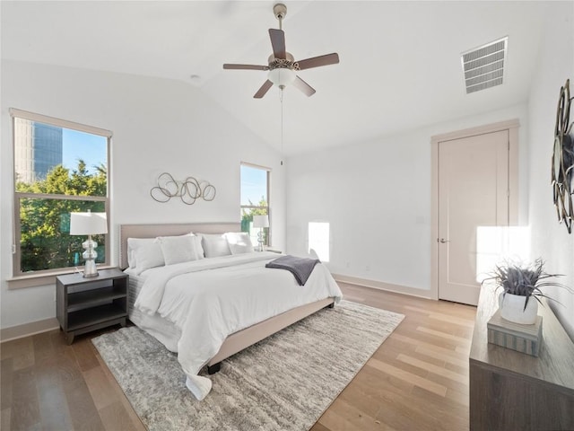 bedroom with hardwood / wood-style flooring, ceiling fan, and vaulted ceiling