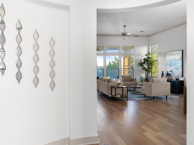 living room with ceiling fan, ornamental molding, and hardwood / wood-style flooring