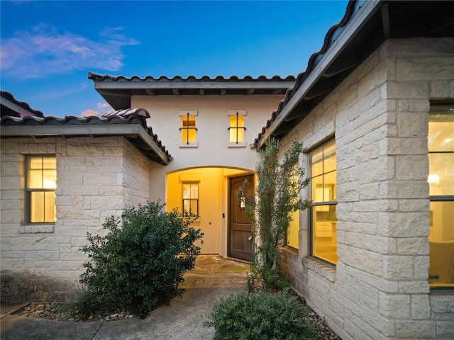 view of exterior entry at dusk