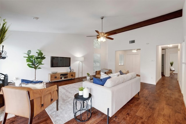 living room featuring vaulted ceiling with beams, dark hardwood / wood-style flooring, and ceiling fan