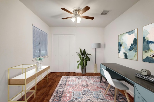 home office featuring dark hardwood / wood-style floors and ceiling fan