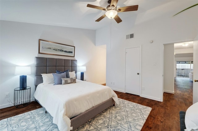 bedroom featuring ceiling fan, dark hardwood / wood-style flooring, and vaulted ceiling